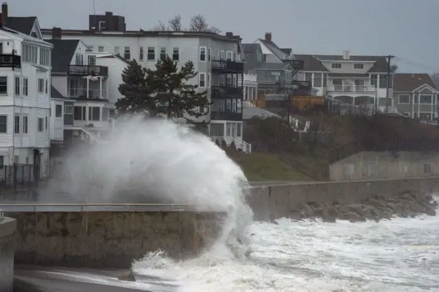 Large waves crash over a sea wall in Winthrop, Massachusetts