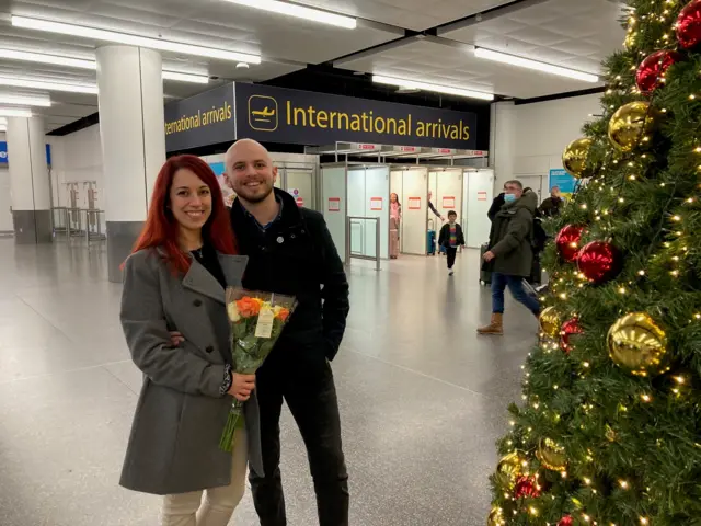 Raquel (Left) holds a bunch of flowers given to her by Dean (Right)