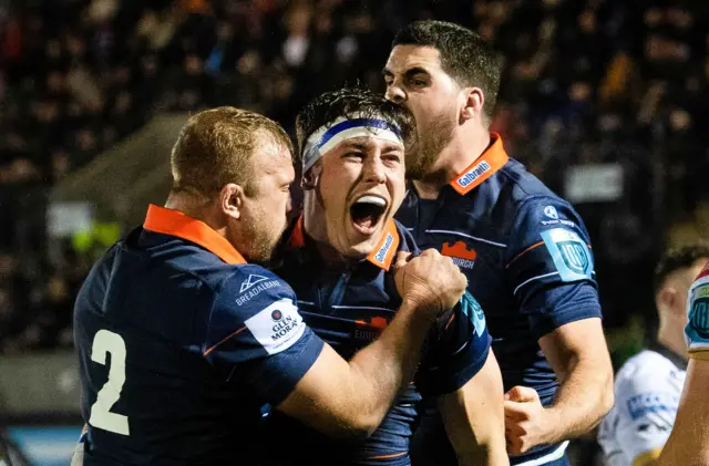 Connor Boyle celebrates his try with Edinburgh teammates