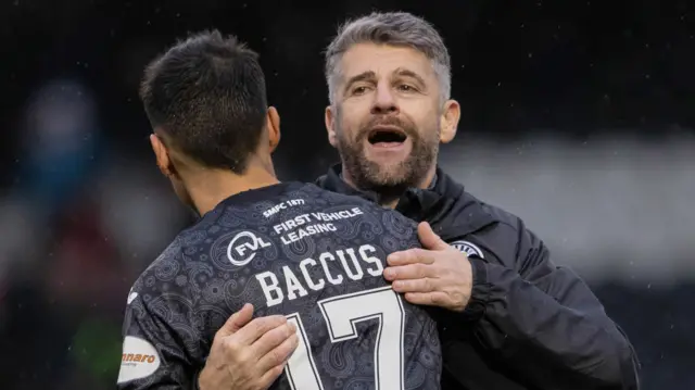 Stephen Robinson celebrates with Keanu Baccus at full-time