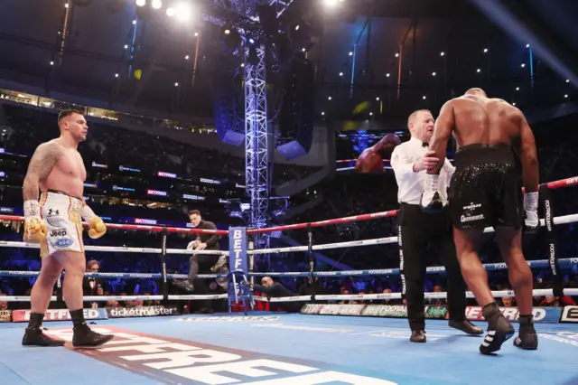 Daniel Dubois is helped by the referee