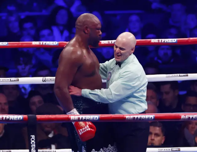 Derek Chisora is consoled by the referee