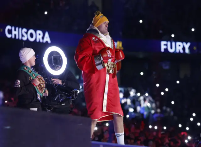 Tyson Fury enters the ring in a red robe