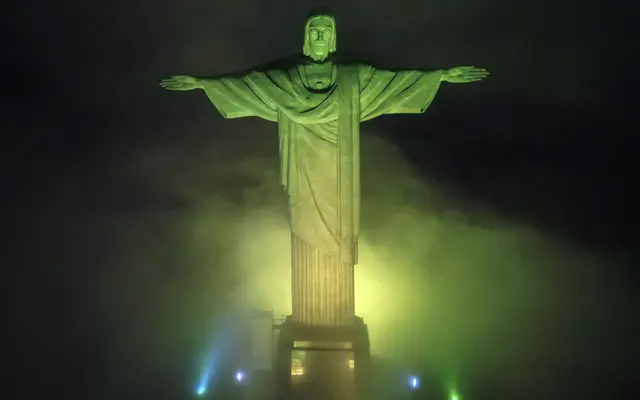 The Christ the Redeemer statue is illuminated with the colors of the national flag in tribute to Pele, in Rio de Janeiro, Brazil