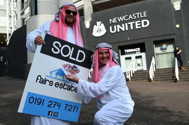 Newcastle fans celebrate the club's takeover