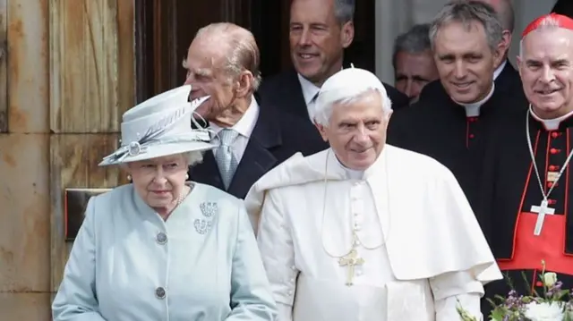 Queen Elizabeth II and Pope Benedict XVI leave to meet school children outside the Palace of Holyroodhouse, the Queen's official residence in Scotland, on September 16, 2010 in Edinburgh, United Kingdom