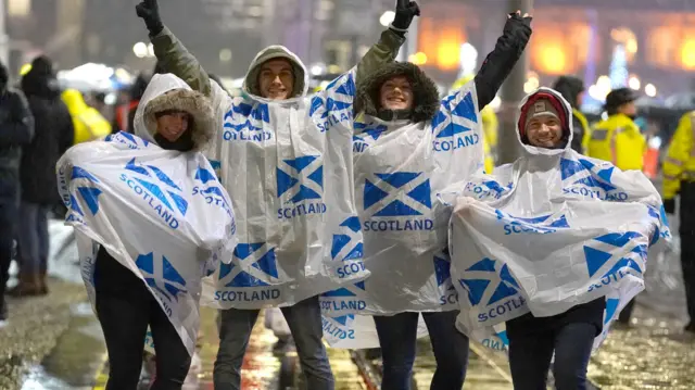 Revellers on Princes Street, before the Hogmanay New Year celebrations in Edinburgh.