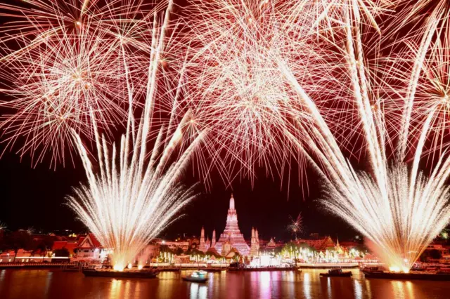 Fireworks explode over the Chao Phraya River during new year celebrations in Bangkok