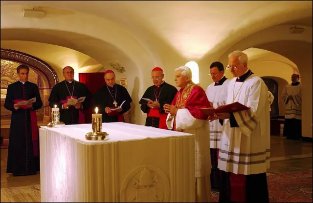 Pope Benedict XVI praying before the tomb of Pope John Paul II and other popes during a visit to the grottoes underneath St Peter's Basilica in the Vatican, marking the day Catholics remember the dead, in November 2005.