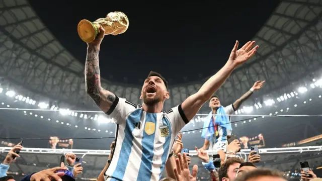 Lionel Messi, of Argentina, celebrates with the World Cup trophy after winning the 2022 final in Qatar - at Lusail Stadium on 18 December 2022.