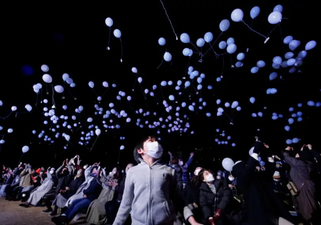 Revellers release balloons as they take part in New Year celebrations in Tokyo, Japan