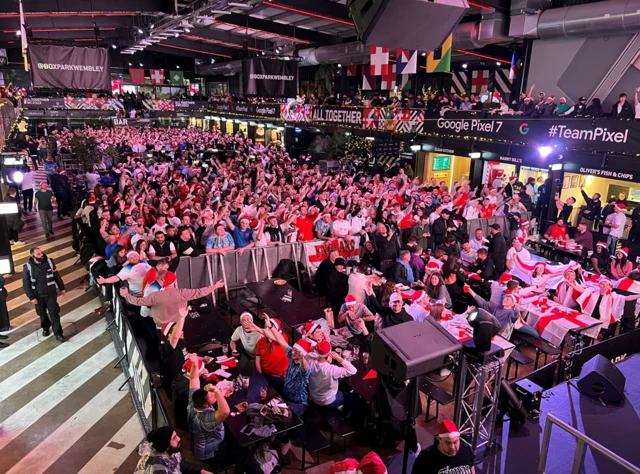 Crowd of England fans watching a big screen ahead of kick off