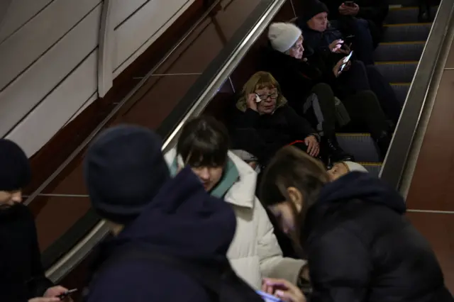 People sat on escalators in the metro station