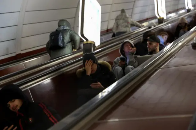 People take shelter inside a metro station in Kyiv