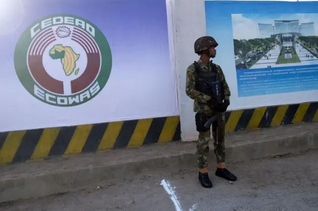 A Nigerian soldier stands outside the new construction site of the headquarters of the Economic Community of West African States