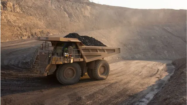 Trucks carry minerals at the Kolwezi mine.