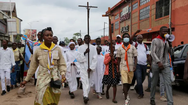 Protesters march during a protest march that was called by Congo's Catholic and Protestant churches to protest against escalating violence in the East of the country, in Kinshasa, Democratic Republic of Congo, December 4, 2022.