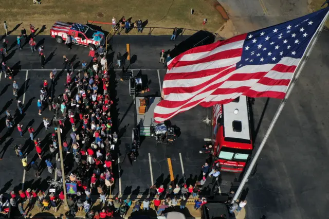 Walker supporters gather near his campaign bus to hear him speak