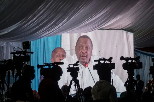 The speech of former Kenya's President Uhuru Kenyatta is broadcast on a screen during the East African Community (EAC)- led Nairobi Process