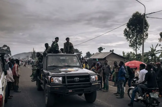 Congolese soldiers return to the front lines in Kanyaruchinya, north of the city of Goma, eastern Democratic Republic of Congo, as war-displaced people flee south, on November 15, 2022