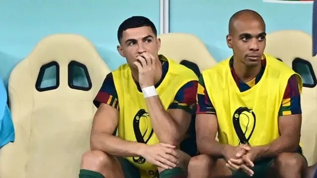 Cristiano Ronaldo watches from the substitutes bench