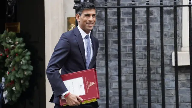 Rishi Sunak walks along Downing Street