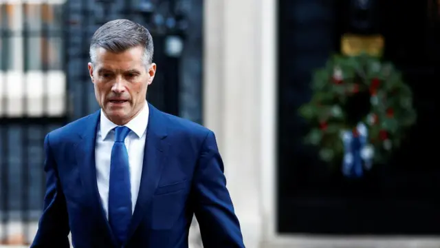 Mark Harper walks along Downing Street