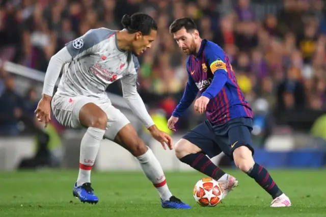 Virgil van Dijk (left) defends against Lionel Messi