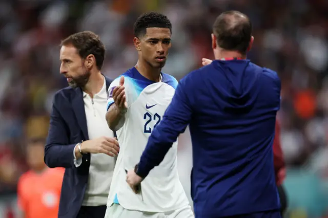 Jude Bellingham shakes hands with Steve Holland as he's substituted against Senegal.