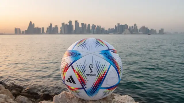 A football before a Doha skyline