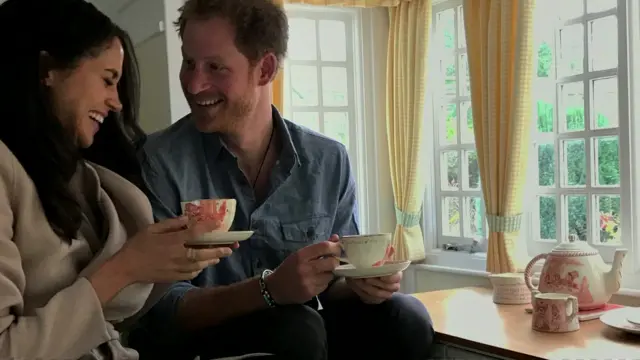 Harry and Meghan are seeing laughing while having tea