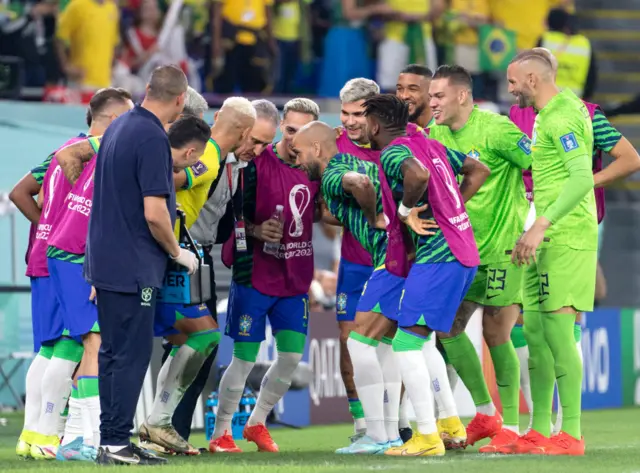 Brazil coach Tite dances with his players