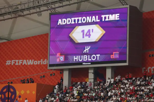 The big screen shows 14 minutes of added time during a 2022 Fifa World Cup match