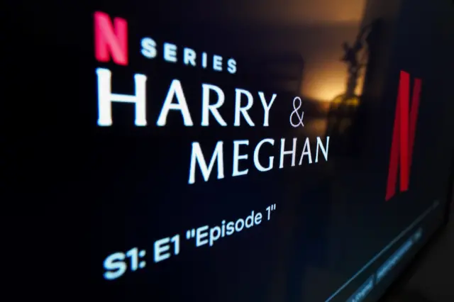 A TV shows a still from the title of the Duke and Duchess of Sussex's Netflix documentary