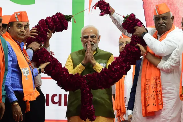 Indian Prime Minister Narendra Modi (C) gestures during a Bhartiya Janta Party (BJP) rally ahead of 2nd phase of Gujarat's assembly election, in Ahmedabad on December 2, 2022