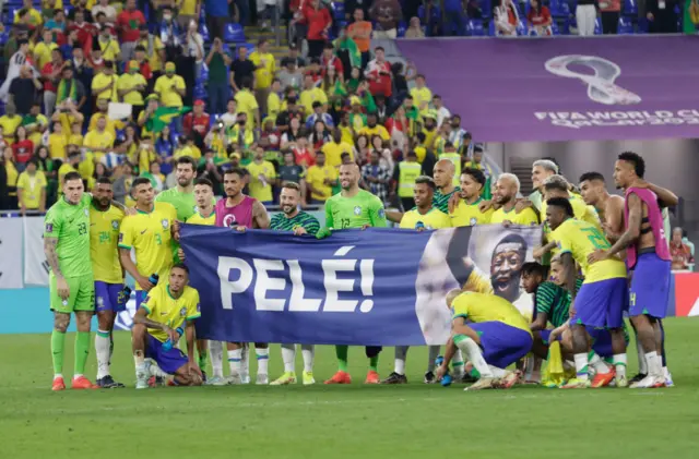 Brazil players unfurl a Pele banner