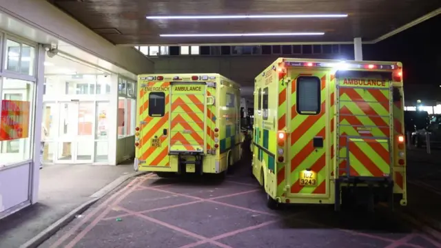 Ambulances wait outside a hospital