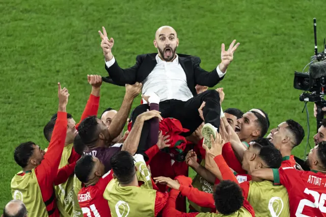 Morocco manager Walid Regragui is thrown up in the air by his players after their win against Spain in the last 16 of the 2022 Fifa World Cup