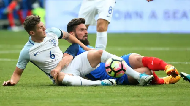 John Stones tackles Olivier Giroud in 2017