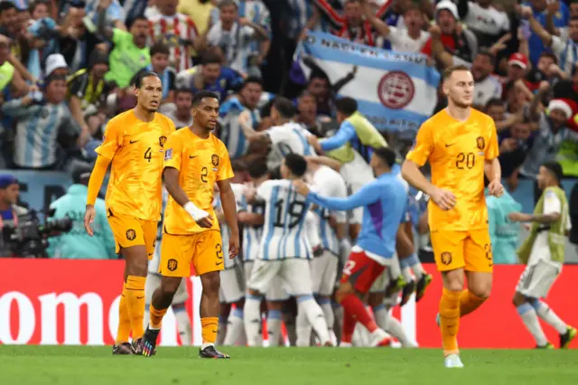 Dejected players of Netherlands react after Lionel Messi of Argentina scored a goal