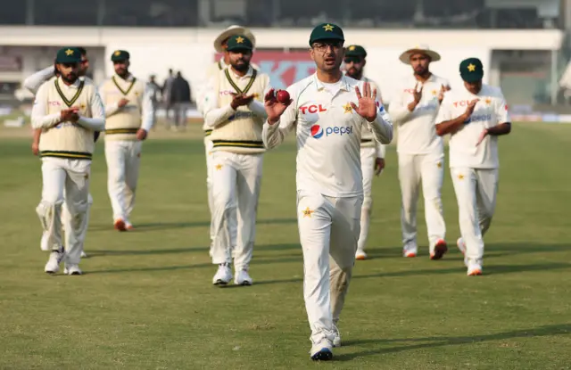 Abrar Ahmed leading the Pakistan team off the field after taking sevenn wickets