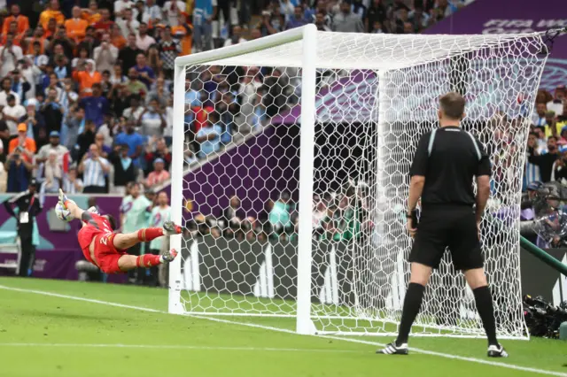 Emiliano Martinez of Argentina saves a penalty from Virgil van Dijk