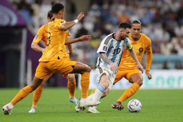 Lionel Messi of Argentina is challenged by Cody Gakpo and Virgil Van Dijk