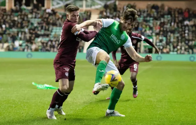 Hibs' Joe Newell holds off Cammy Devlin at Easter Road