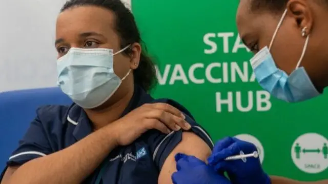 NHS worker being vaccinated.