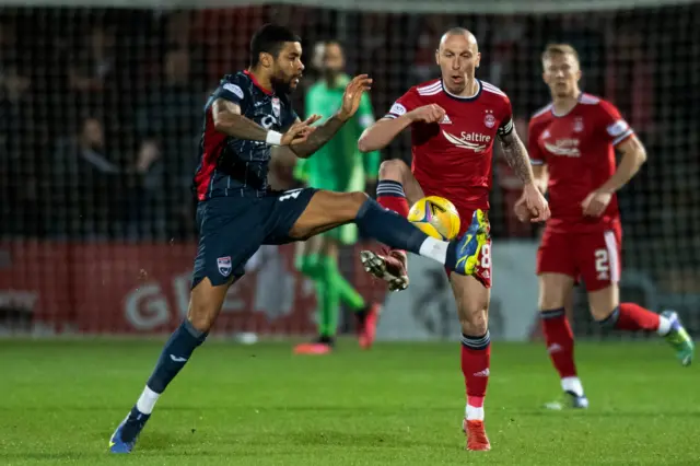 ​​Ross County's Dominic Samuel and Aberdeen's Scott Brown challenge for the ball