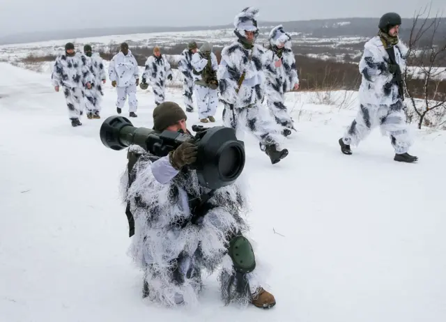 Ukrainian service member holding anti-tank weapon during drills near Yavoriv, Ukraine