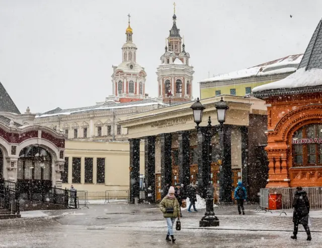 A woman walks during a snowfall in Moscow, Russia, on 10 February 2022