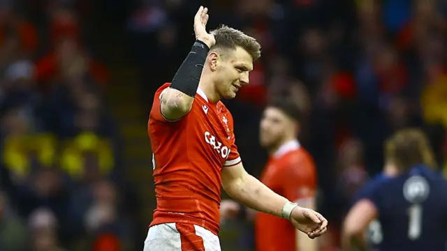 Dan Biggar waves to the crowd as he goes off towards the end