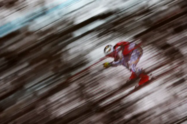 A skier is blurry in flight